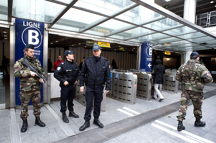 Toulouse shooting: Soldiers and policemen stand guard in the subway one day after the shooting
