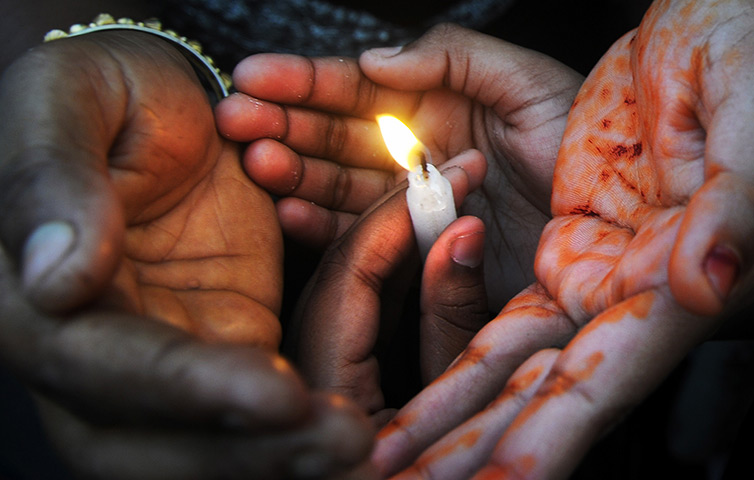 24 hours in pictures: Kolkata, India: Women's rights activists hold candles