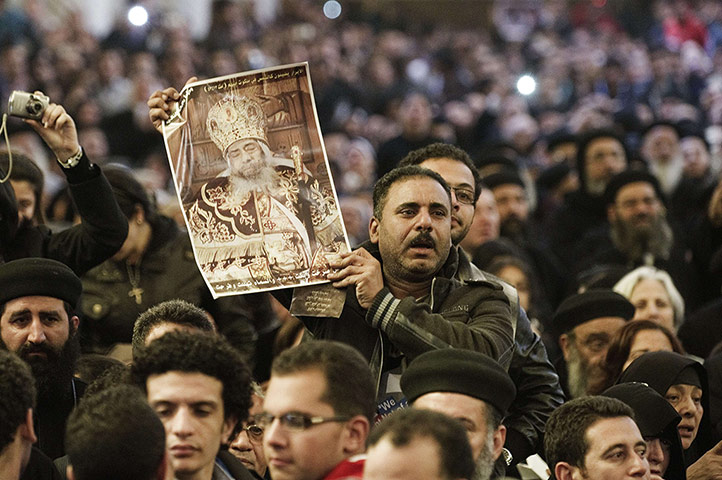 Pope Shenouda Funeral: An Egyptian Coptic Christian holds a portrait of Pope Shenuda