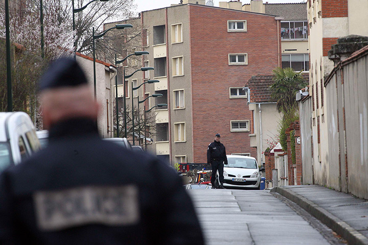Toulouse seige: French police block a street during a raid on a five storey building