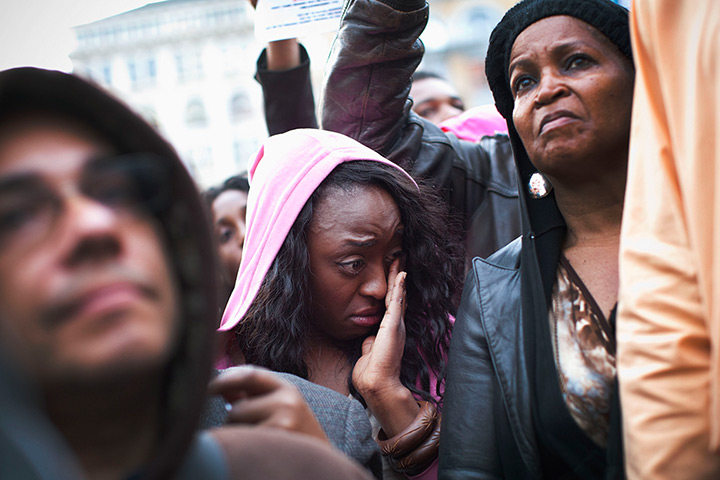 Trayvon Martin march: A woman wipes away a tear during the protest