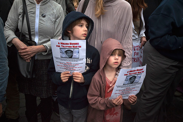 Trayvon Martin march: Boys hold images of slain Florida teen Trayvon Martin