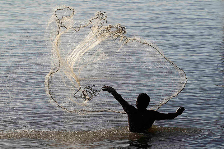 World Water Day: A fisherman casts a net over the waters 