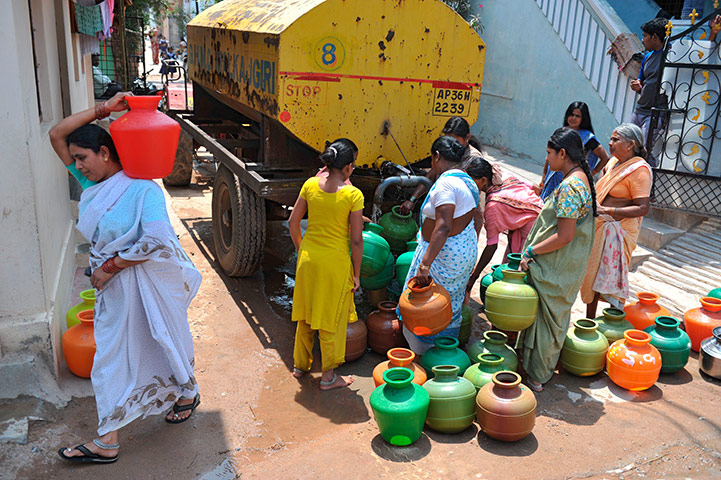 World Water Day: Indian women fill containers with drinking water