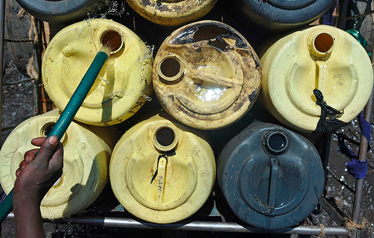 World Water Day: A water-vendor collects water in jerrycans 