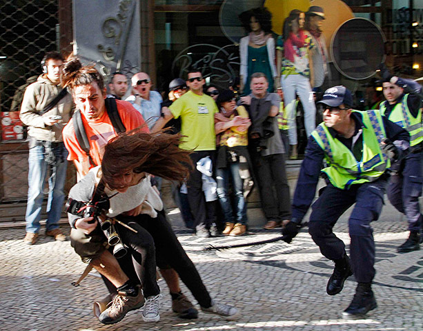 Patricia Melo: A policeman strikes AFP photojournalist Patricia Melo
