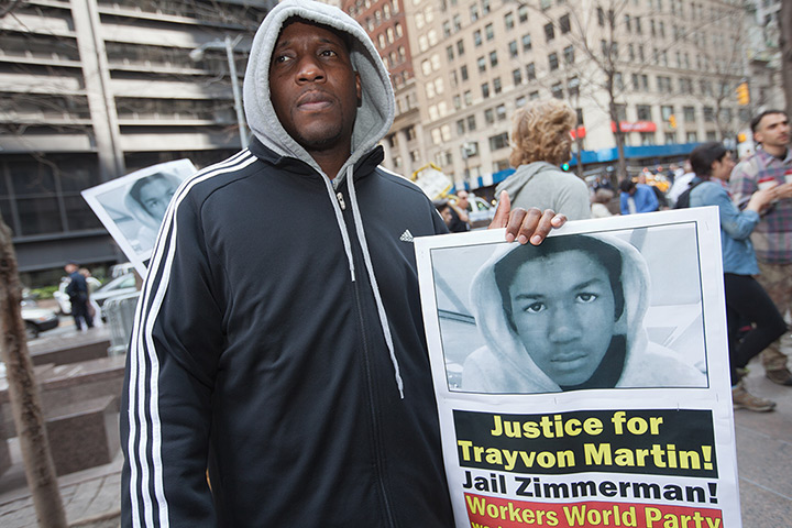 Occupy Wall Street march: An activist holds a poster calling for justice for Trayvon Martin
