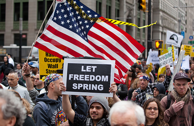 Occupy Wall Street march: Occupy Wall Street protesters brandish signs