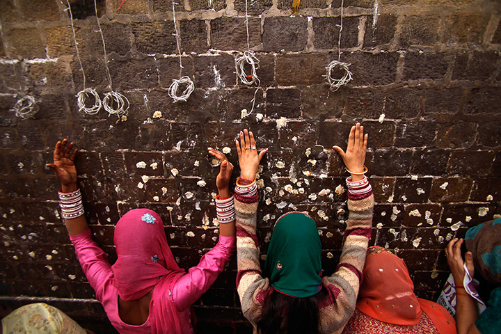 24 hours in pictures: Hindu devotees pray outside the Kali Temple  in Jammu
