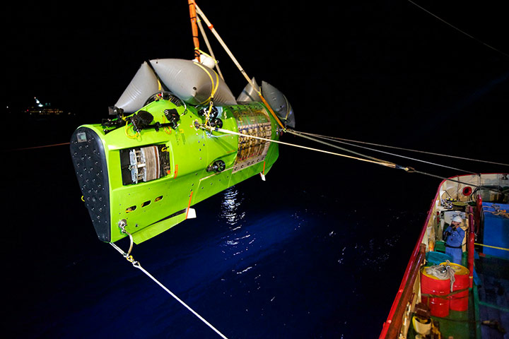 Deepsea: The Deepsea Challenger submersible is hoisted into the Pacific Ocean.