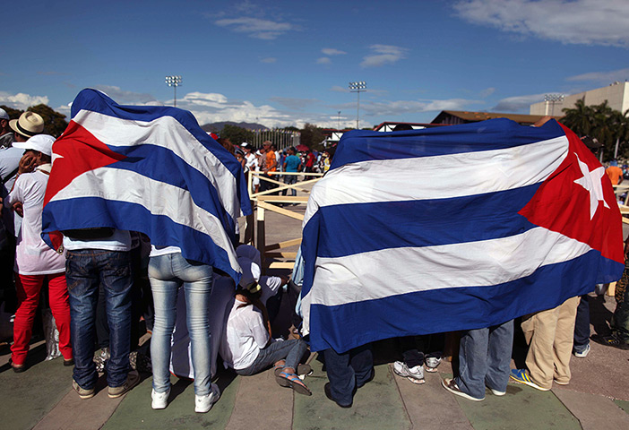 24 hours in pictures: Santiago de Cuba, Cuba: People wait for the arrival of Pope Benedict XVI