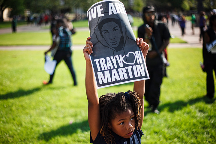 24 hours in pictures: Houston, US: A child holds a sign as supporters gather for Trayvon Martin