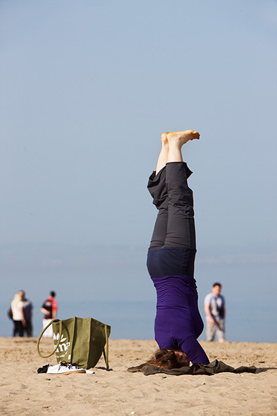 Weather UK: Woman does yoga on Portobello beach, Edinburgh