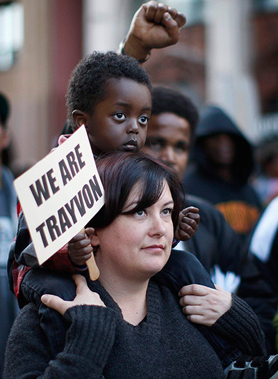 Trayvon Martin marches: A woman carries a child during the Million Hoodies March in Los Angeles