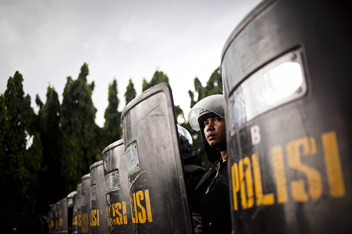 24 hours: Jakarta, Indonesia: Police stand in line during protests