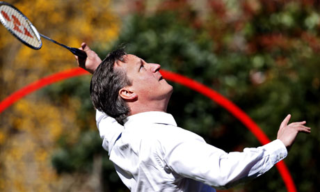 David Cameron smashes the shuttlecock as he plays badminton in the garden of 10 Downing Street