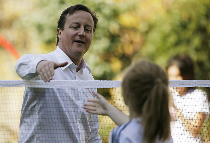 David Cameron badminton: David Cameron shakes the hand of a school athlete after playing a game