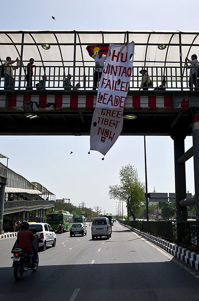 Tibet Protests: Tibetan activists unfurl a banner reading 