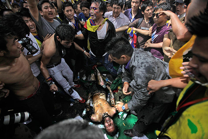 Tibet Protests: Jampa Yeshi lies on the ground after he lit himself on fire 