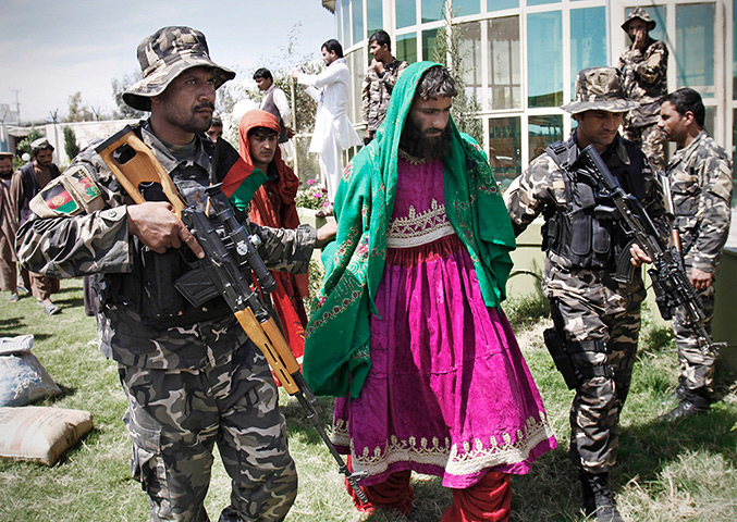 24 hours in pictures: Afghan security forces escort Taliban militants in Afghan women dresses