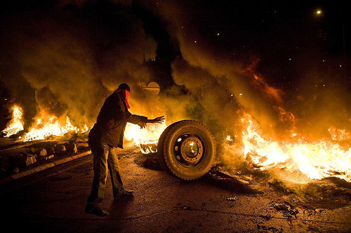 24 hours in pictures: Barricade of burning tyres at the main entrance of Mercabarna