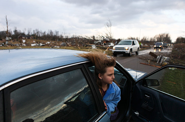 Tornado Updated: Janessa Lewellyn looks at her grandparents house after a tornado in Indiana