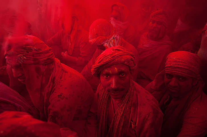 24 Hours: Indian villagers smear themselves with colours at the Lathmar Holi festival