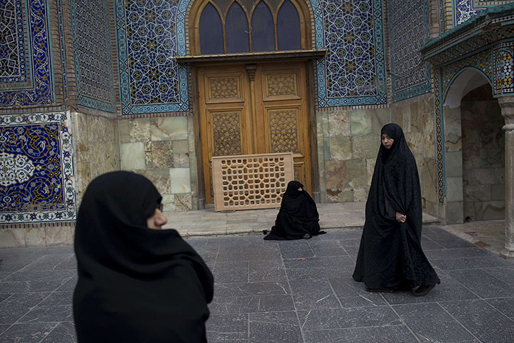 24 Hours: Women walk in the courtyard of Massoumeh holy shrine in Iran