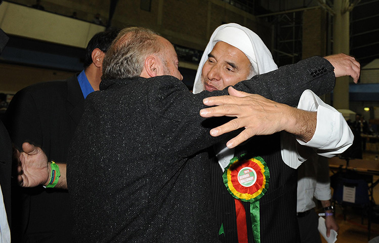 George Galloway win: George Galloway is hugged by Mohammed Iqbal to hear the results 