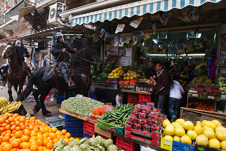 Land Day protests: Israeli police officers ride through fruit market,  Jerusalem