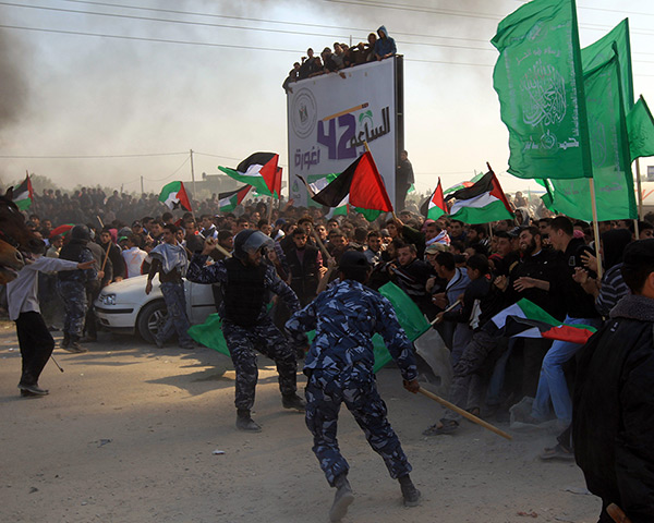 Land Day protests: Members of the Hamas security forces restrain Palestinian protesters