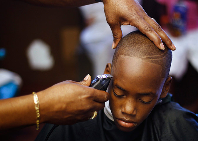 24 hours: Devonte Brown has his hair cut by David McKnight in Sanford, Florida