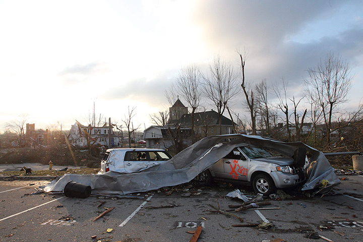 Midwest tornado: Cars and debris are strewn in front of of Henryville High School in Indiana