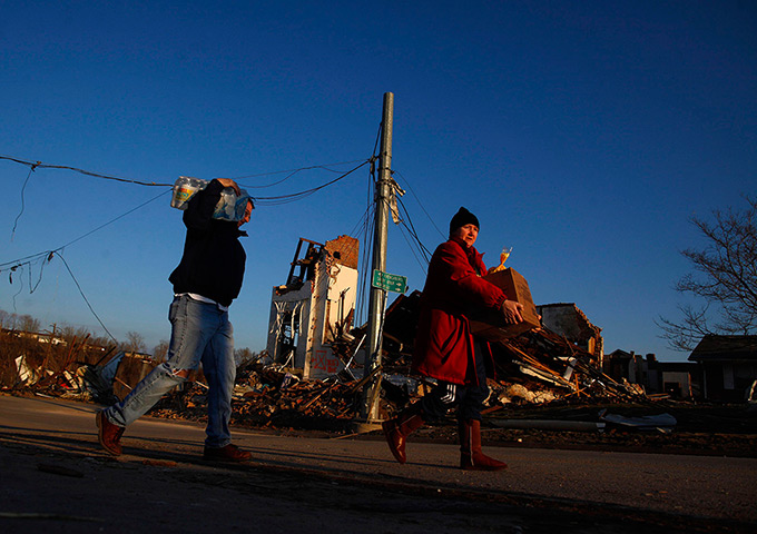 Midwest tornado: People carry supplies past a damaged church in West Liberty, Kentucky