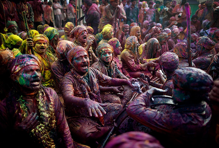 Lathmar Holi : Indian Hindu worshippers covered in various coloured powders sing prayers