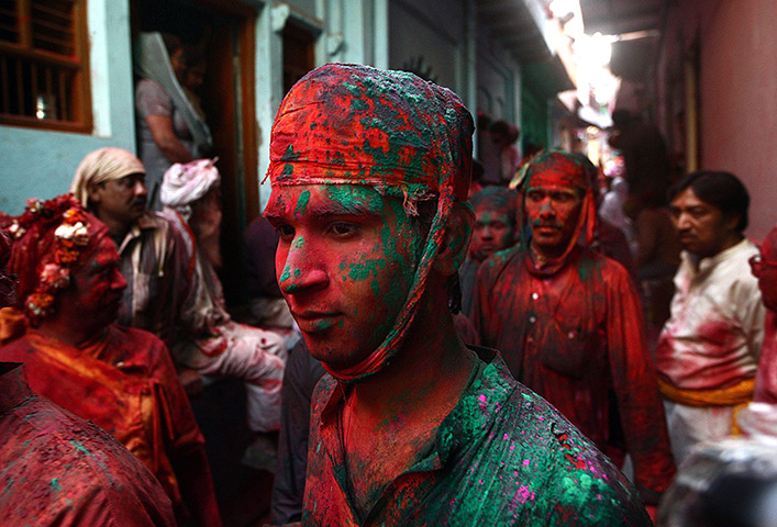 Lathmar Holi : A man is covered with coloured powder called Gulal in Barsana