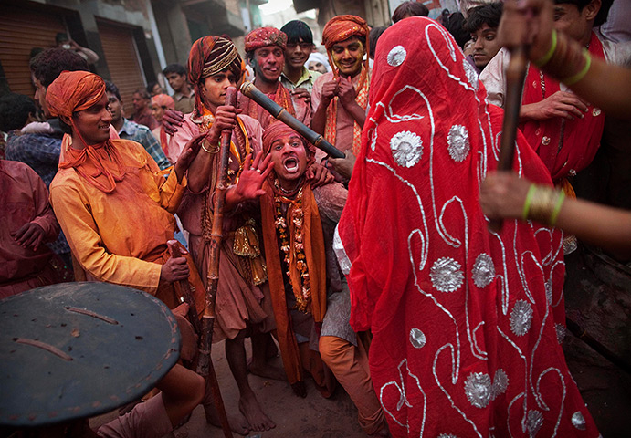 Lathmar Holi : A man from Nandgaon shouts as he is about to be hit by a woman from Barsana