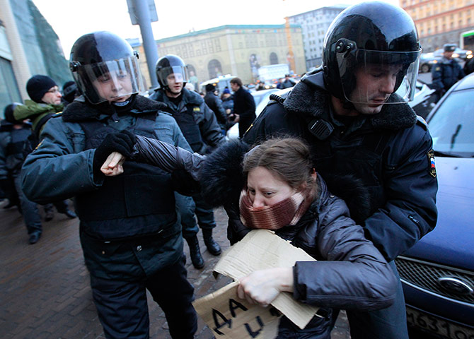 Putin protest: Russian police officers detain an opposition protester