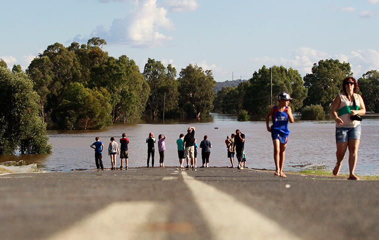 Flooding in Australia: Local residents look at a road submerged in floodwaters near Wagga Wagga