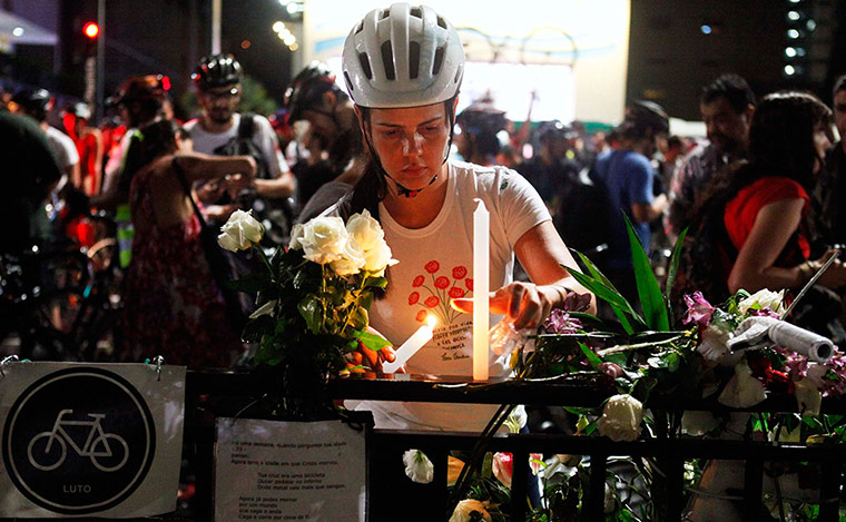 Women protesting: A woman lights candles during a protest