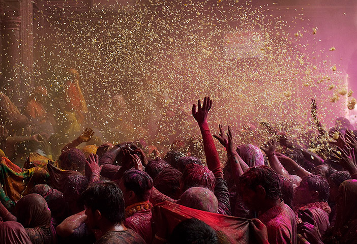 24 Hours: Vrindavan, India: Flowers are thrown on Hindu devotees during 'Holi'