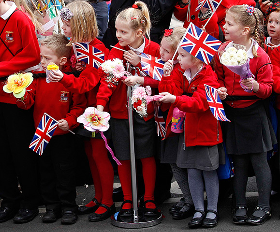 Royals in Leicester: Schoolchildren wait to see The Queen during her visit to the Cathedral