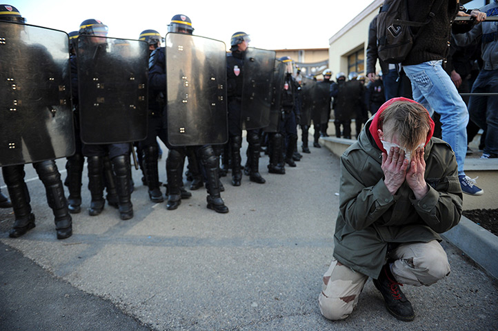 24 hours in pictures: Saint-Just-Saint-Rambert, France: A man holds his face during a protest