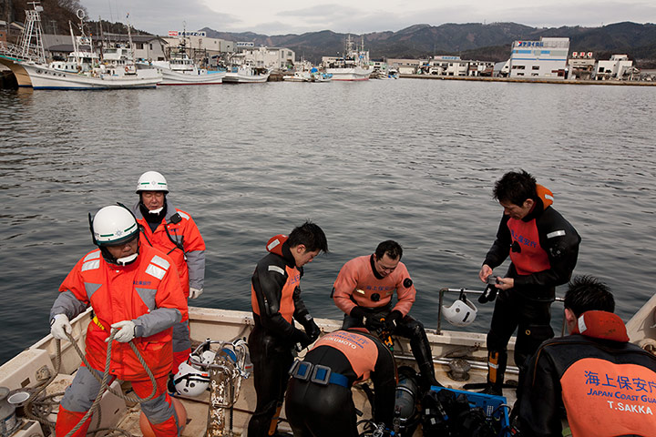Japan tsunami: Divers search the harbour for bodies, Kesennuma, Japan