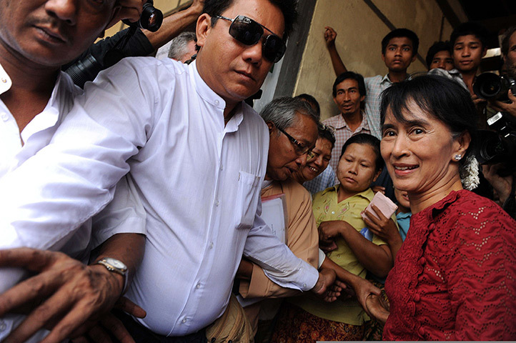 Burma elections: Aung San Suu Kyi is surrounded by supporters and journalists