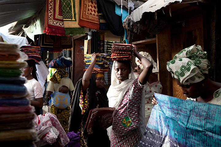 24 hours: Bamako, Mali: Cloth sellers wait for customers at the Grand Market