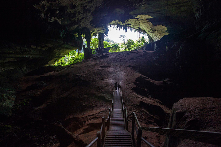 24 hours: Tourists walk towards the main entrance of the Niah Great Cave Sarawak 