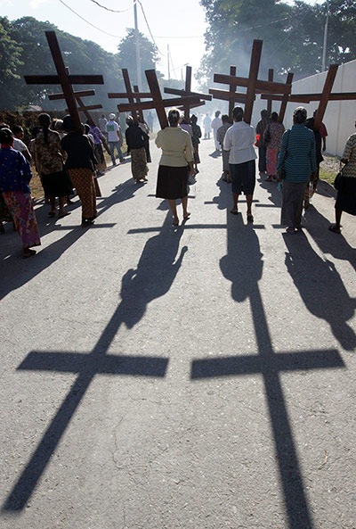 Palm Sunday: East Timorese Catholic women carry wooden crosses in a procession in Dili