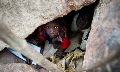 Children hide from Sudan warplanes in Nuba mountains