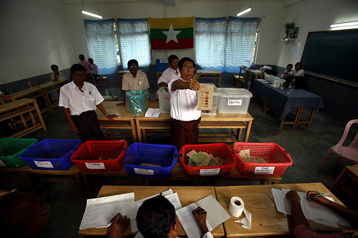 Burma elections count: Election officials count the ballots at a polling station in Mayangone